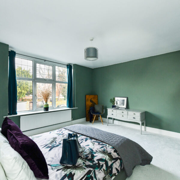 Serene-green-bedroom-with soft-lighting-and-cosy-bedding-emma-martin-interiors-nottingham